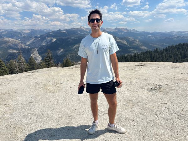 Photo of study abroad alumni posing for photo on mountain