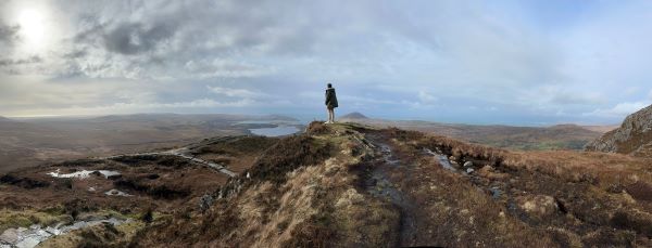 Study abroad alumni standing on mountain overlooking view