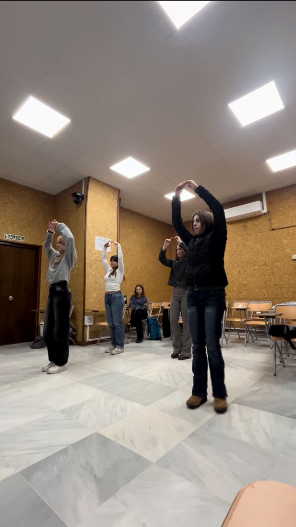Study abroad students performing a flamenco dance during class
