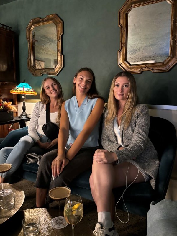 Three study abroad students posing for a photo at local restaurant