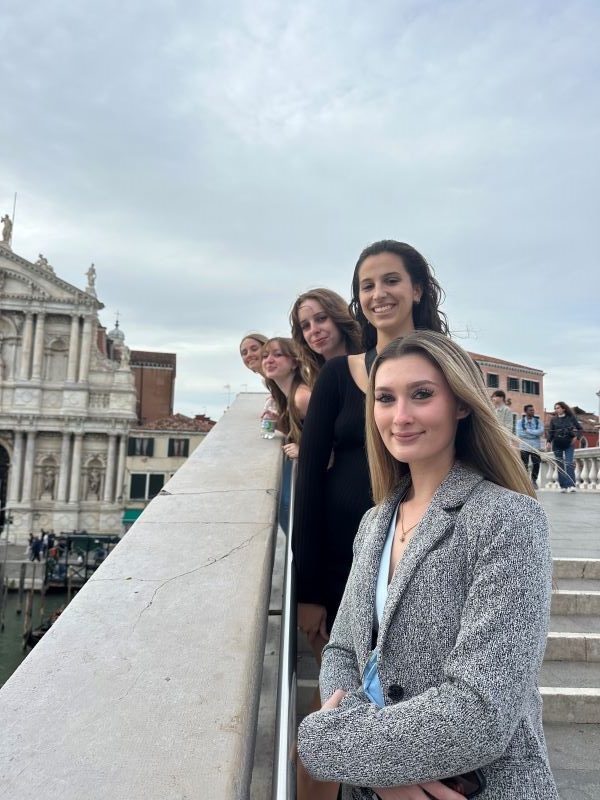Photo of 5 study abroad students posing for photo on stairs