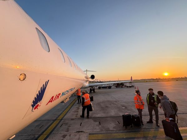 Airplane and tarmac with bright sunset