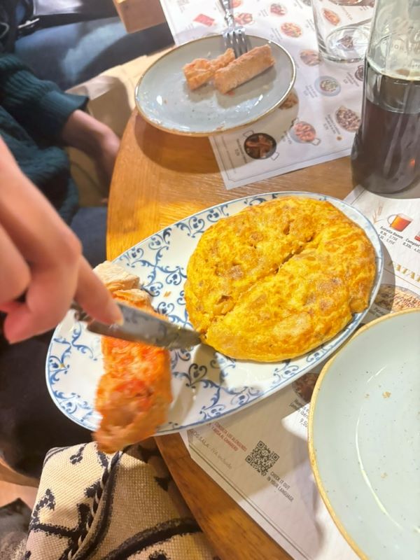 Study abroad student cutting tortilla in half