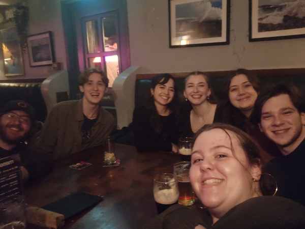 Study abroad students taking a selfie while sitting at a table at Massimos