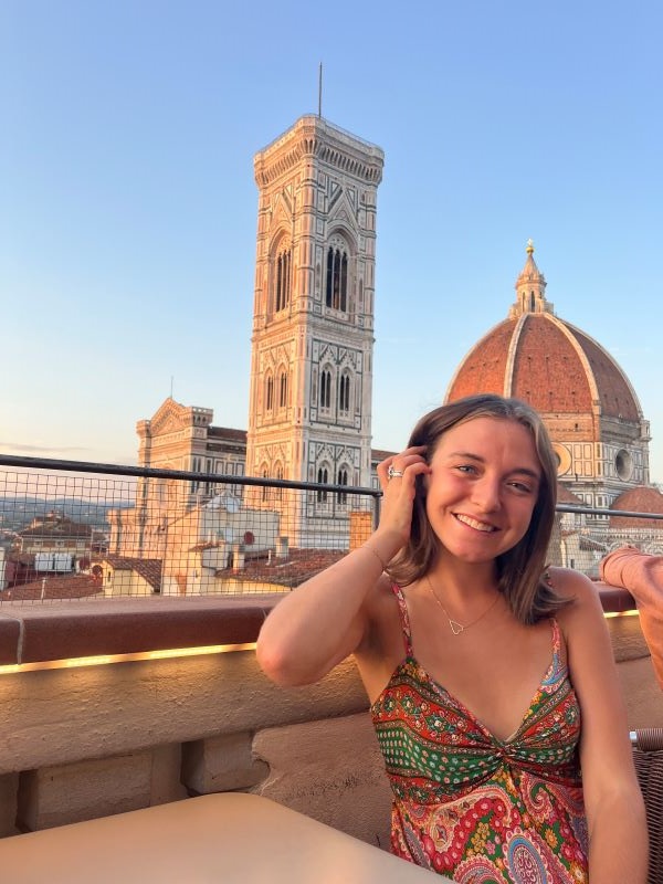 Study abroad student posing for photo on roof overlooking Florence