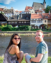 Students sitting by a river