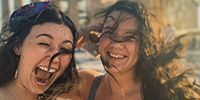 Students taking a selfie as they jump