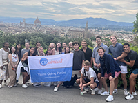 Students posing at scenic overlook of the city