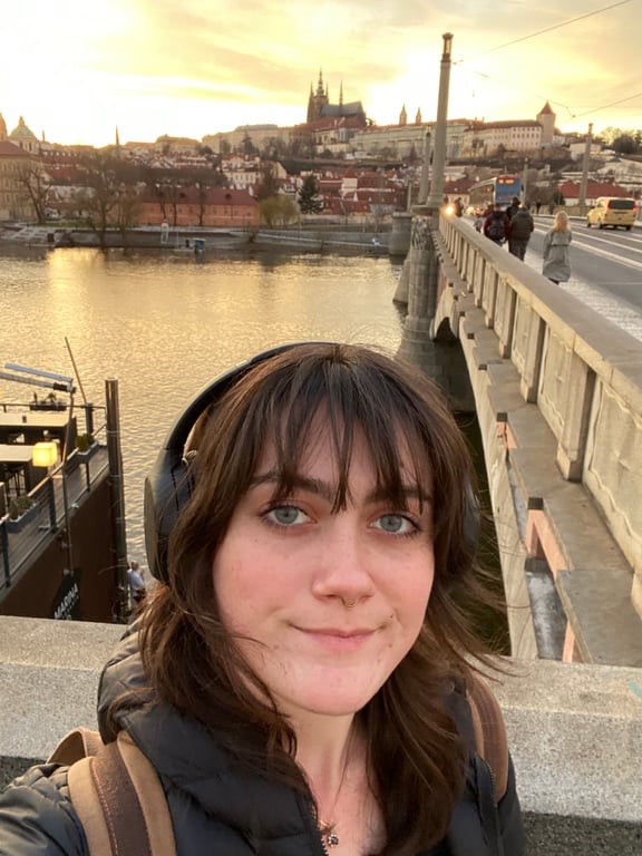 a study abroad student taking a selfie near a bridge and water