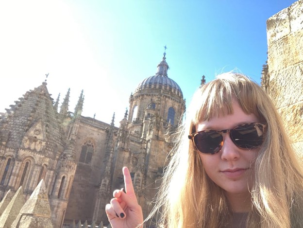 a study abroad student taking a selfie in front of a cathedral