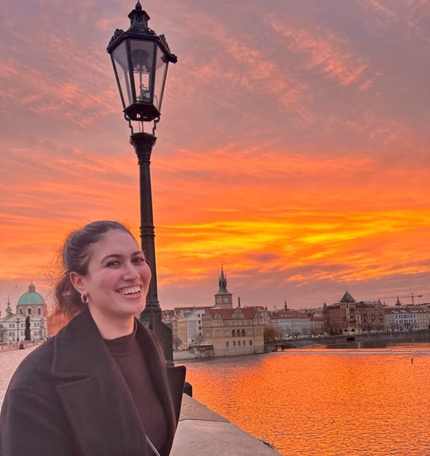 a study abroad student on a bridge during sunset