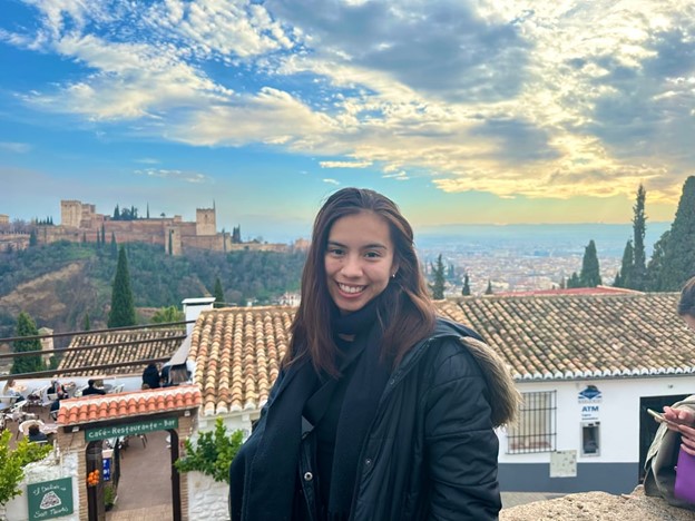 a study abroad student smiling for a picture above a Spanish city