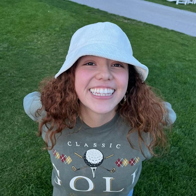 a study abroad student wearing a hat and smiling